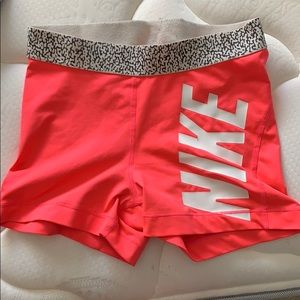 Bright pink Nike Pro spandex shorts